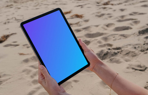 iPad Air mockup held by a user at the beach