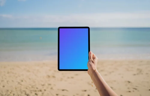 iPad Air mockup held by user at the beach 