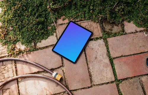 iPad Air mockup on a garden paving with plants