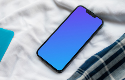 iPhone 13 mockup on bed