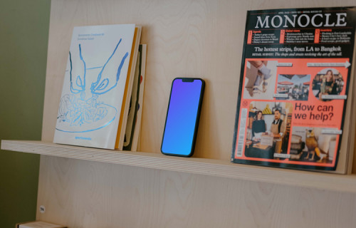 iPhone 13 mockup on bookshelf