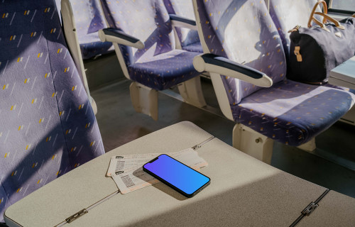 iPhone 13 mockup on table in train