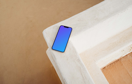iPhone 13 Pro mockup beside a brown wall