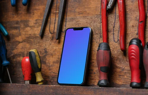iPhone 13 Pro mockup beside work tools