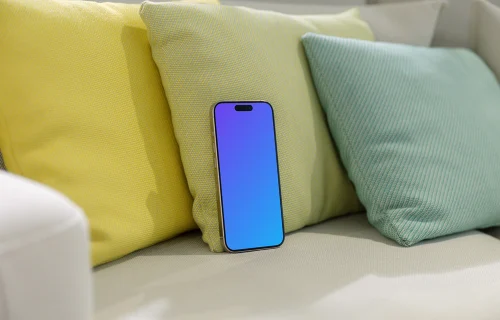 iPhone 15 Pro mockup on a cozy sofa with colorful cushions
