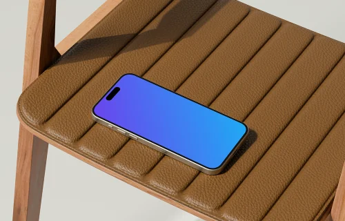 iPhone 16 mockup on a leather chair