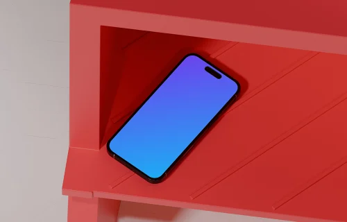iPhone 16 mockup on a red shelf