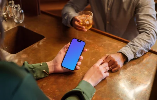 iPhone mockup held by woman in the lounge setting