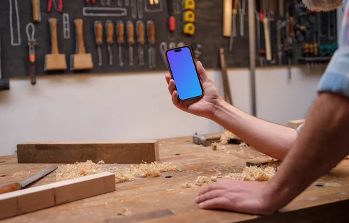 iPhone mockup in carpenter's hand