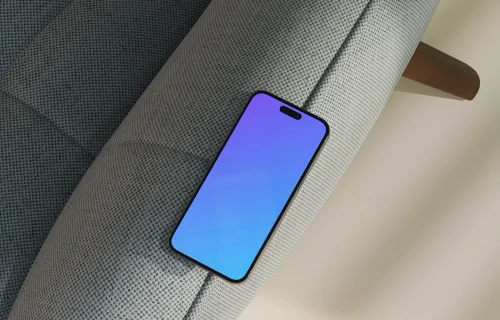 iPhone mockup on a modern fabric sofa
