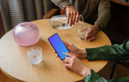 Lounge setting and woman working on a Google Pixel mockup