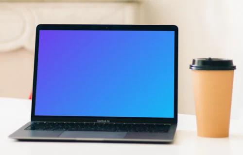 MacBook Air mockup beside a cup of coffee