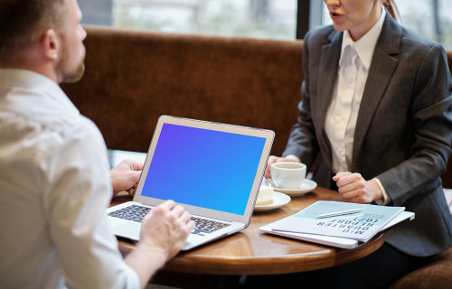 MacBook Air mockup used in a business meeting