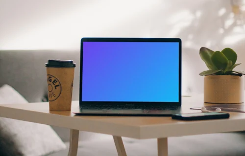 MacBook Pro mockup beside a cup of coffee