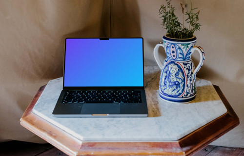 MacBook Pro mockup next to a potted plant
