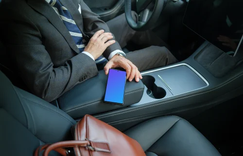 Male entrepreneur in Tesla holding a phone