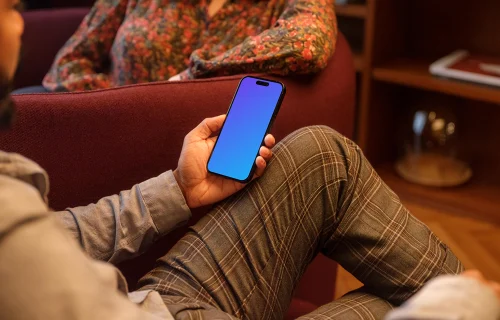 Male hand holding a phone in lounge