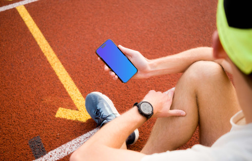 Male runner holding an iPhone 14 Pro mockup