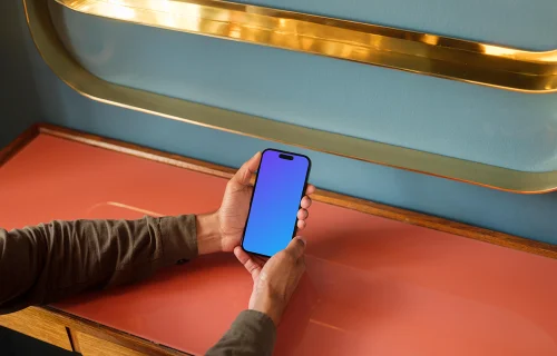 Man holding a phone in the lounge