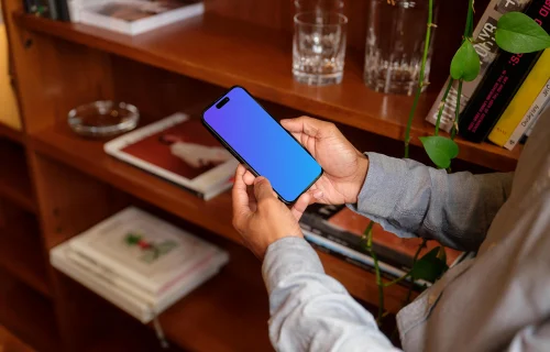 Man holding a phone mockup in the office