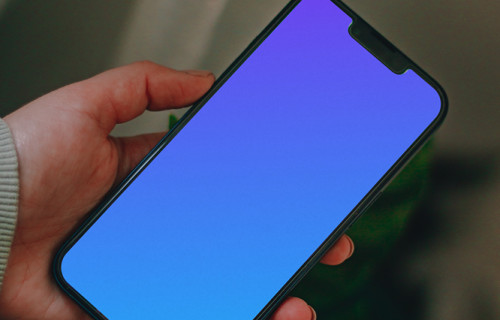 Man holding an iPhone 13 mockup