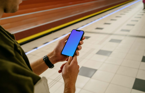 Man holding phone mockup at the subway station
