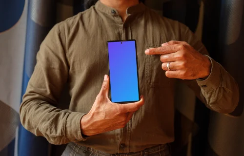 Man in khaki shirt holding a Google Pixel 6 mockup