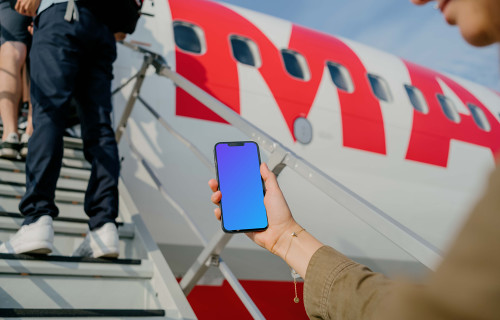 Man looking at an iPhone 13 mockup