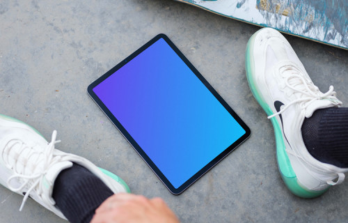 Man sitting next to an iPad Air mockup
