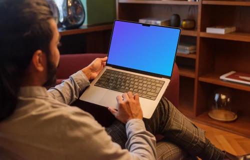 Man working on a MacBook Pro in office