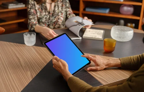 Man working on tablet mockup in the lounge