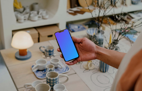 Person reading on iPhone 13 mockup