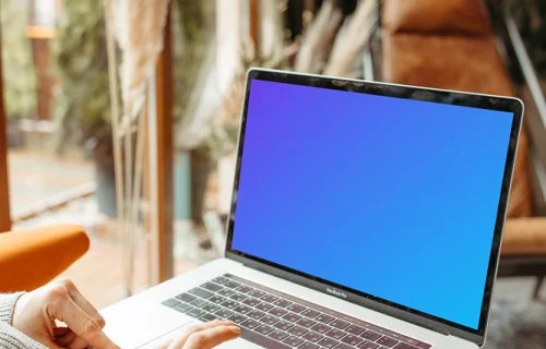 Person typing on a MacBook Pro mockup