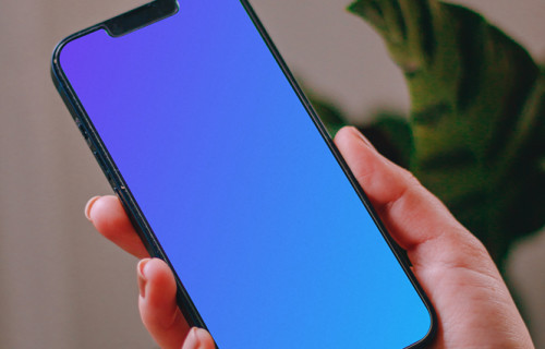 Person using an iPhone 13 mockup