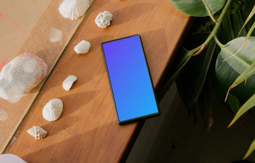 Pixel 6 mockup beside some seashells