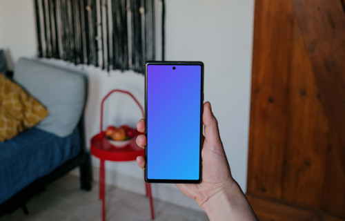 Pixel 6 mockup held by a user in a living room