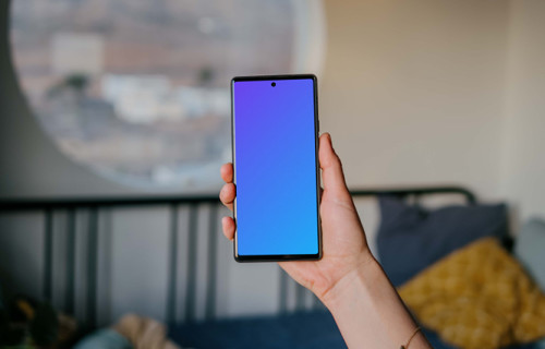 Pixel 6 mockup held by user in a bedroom