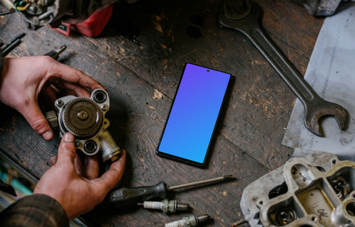 Pixel 6 mockup in front of a man seating at a workbench