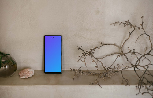 Pixel 6 mockup next to a teapot and plant