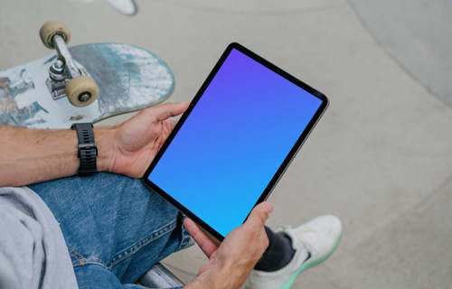 Skateboarder holding a tablet mockup