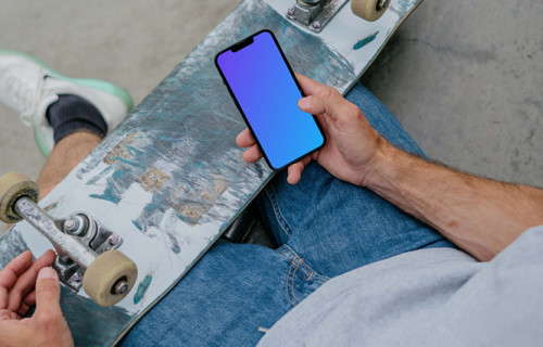 Skateboarder typing on an iPhone mockup