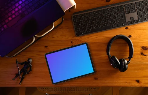 Tablet mockup on wooden desk with creative gadgets