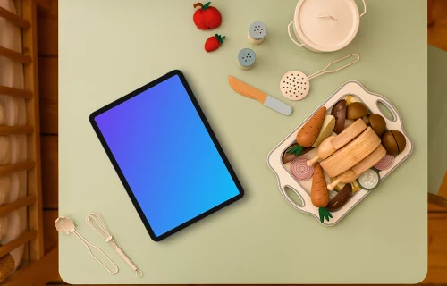 Tablet mockup surrounded by children’s play kitchen set