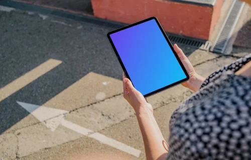 User holding an iPad Air mockup