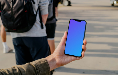 User's hand holding a phone mockup