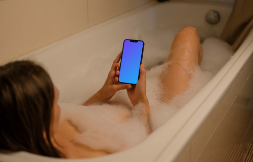 User's hands holding an iPhone 13 mockup