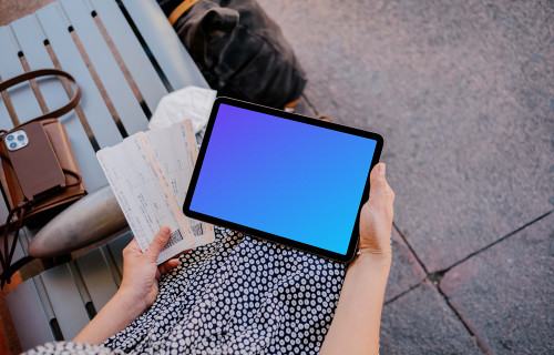 Woman hand holding an iPad Air mockup