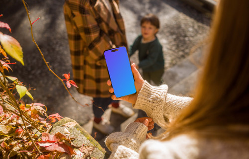 Woman hand holding an iPhone 14 Pro mockup