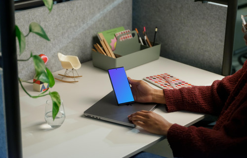 Woman holding a Google Pixel 6 mockup in office