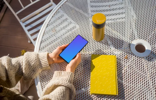 Woman holding a Google Pixel during autumn mockup